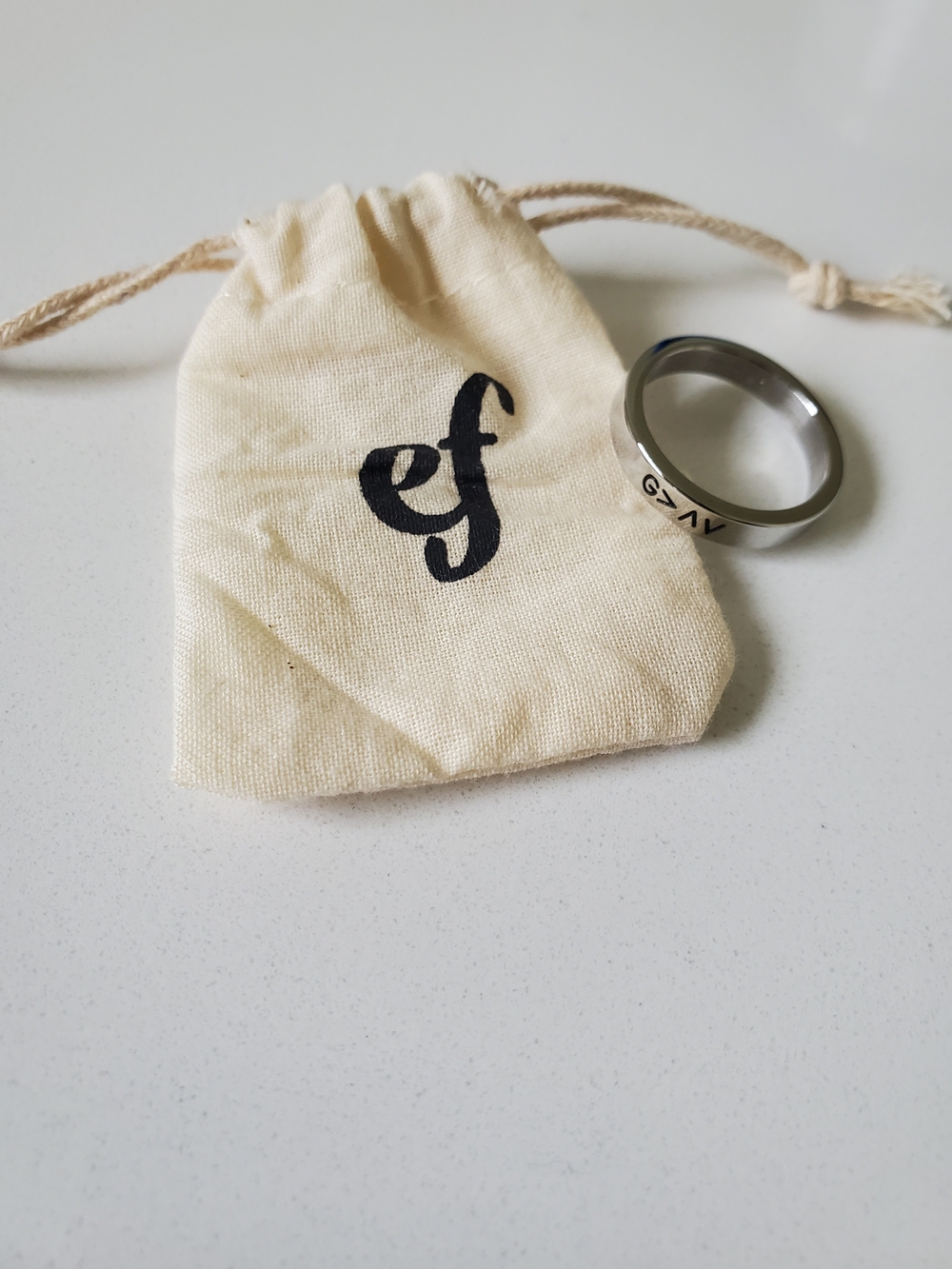 Engraved Stainless Steel Ring with Cream Drawstring Pouch
